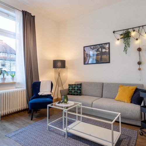 Ferienhaus Kellerwald Gemütliches Wohnzimmer mit grauem Sofa und stilvollem Dekor Ferienhaus Edersee