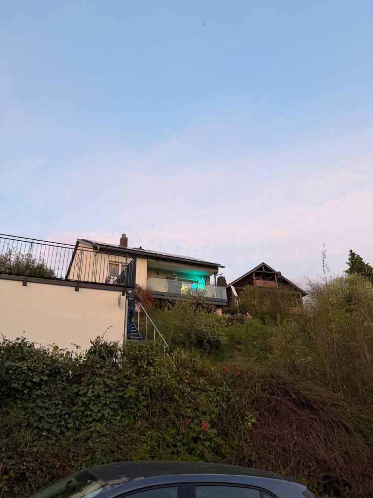 Hillside house with illuminated balcony at sunset, Edersee vacation home, Kellerwald vacation home