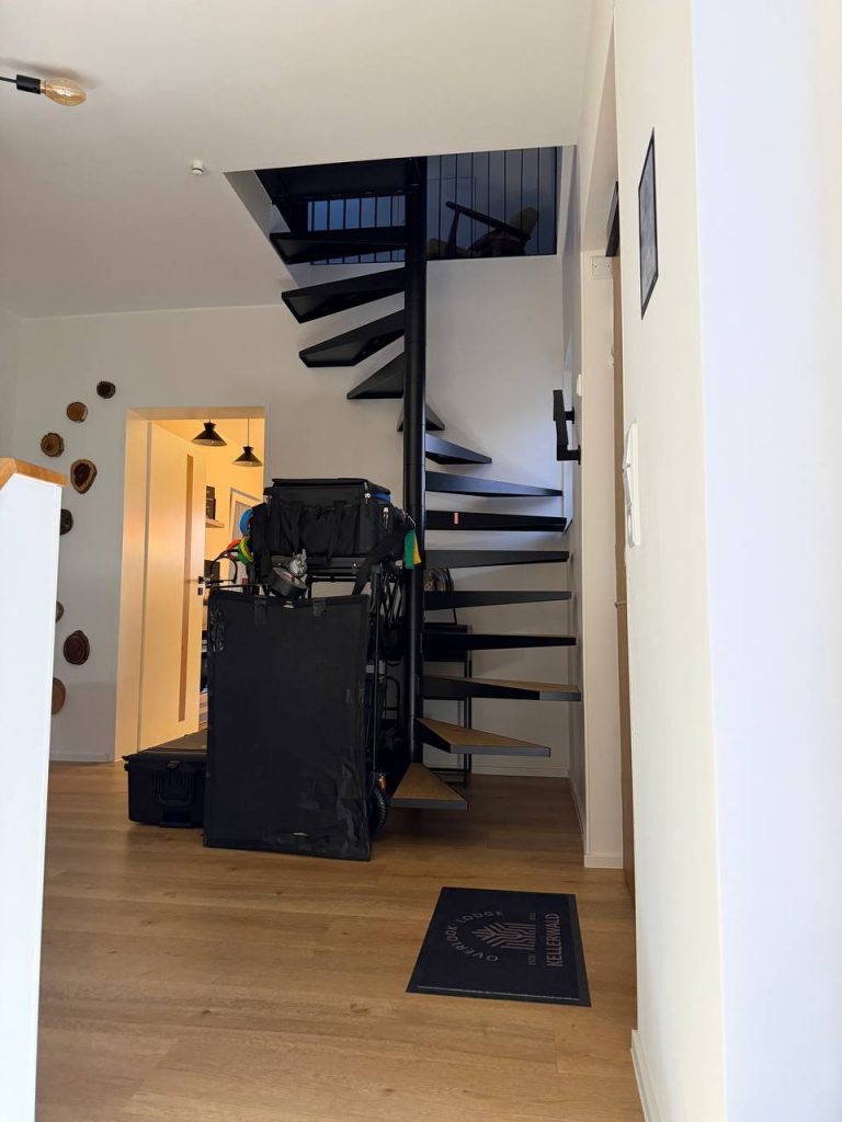Black spiral staircase in modern house with wood floor, Edersee vacation home, Kellerwald vacation home