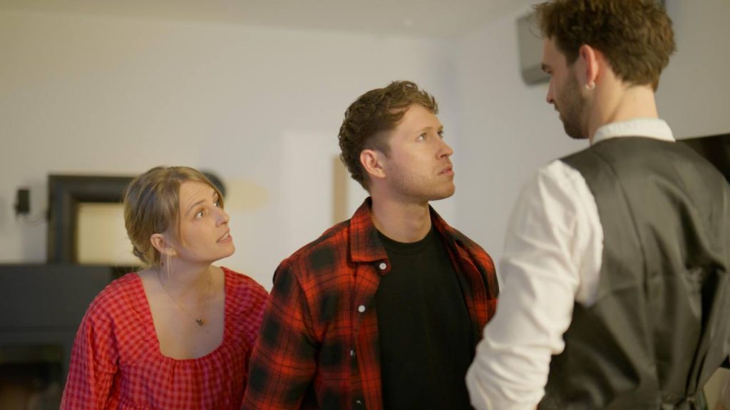 Three people in intense discussion in the living room, Edersee vacation home, Kellerwald vacation home