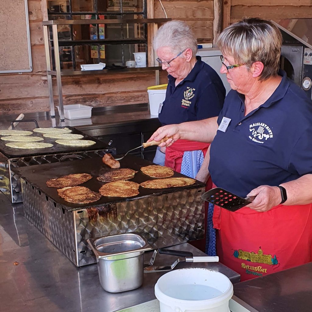 Two women baking oven cakes.