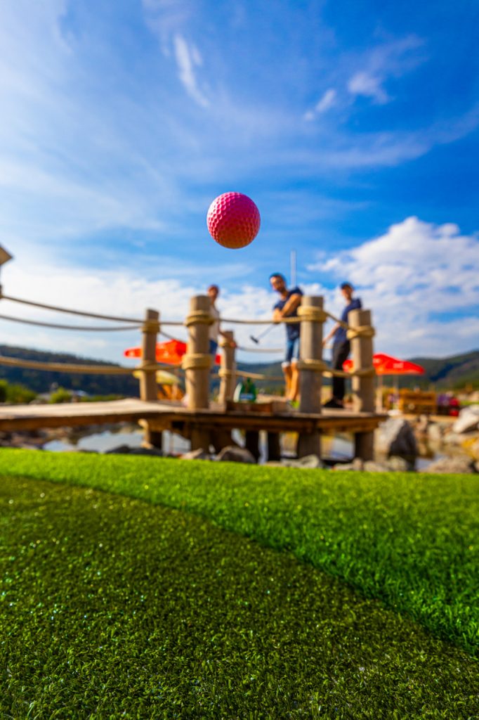 Mini-golf game on a sunny course with a flying pink ball, vacation home Edersee, vacation home Kellerwald
